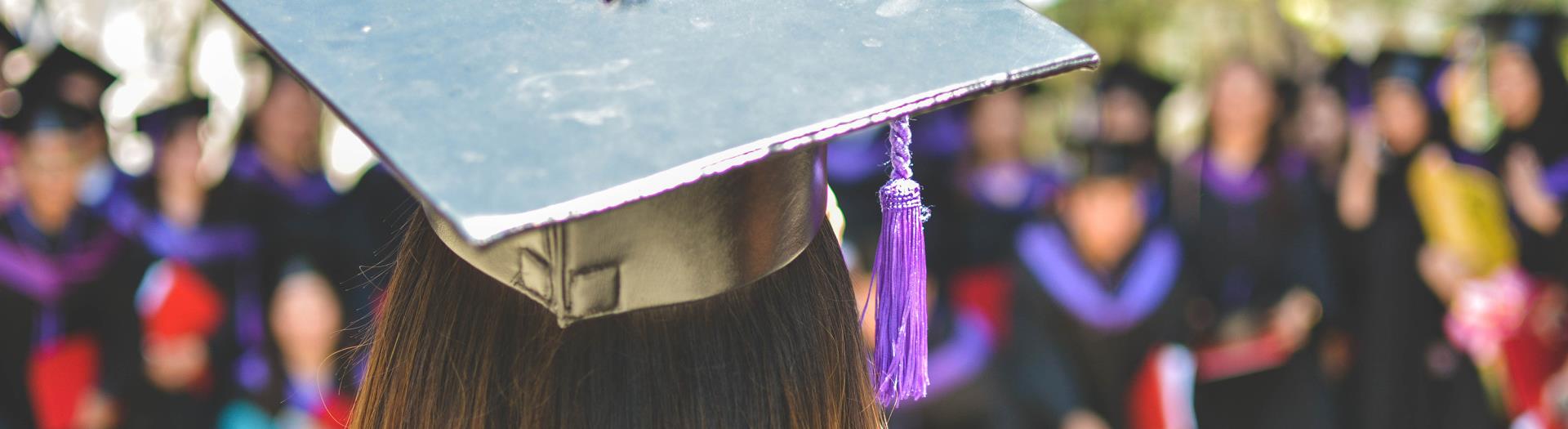 image of a college student from behind in a cap and gown