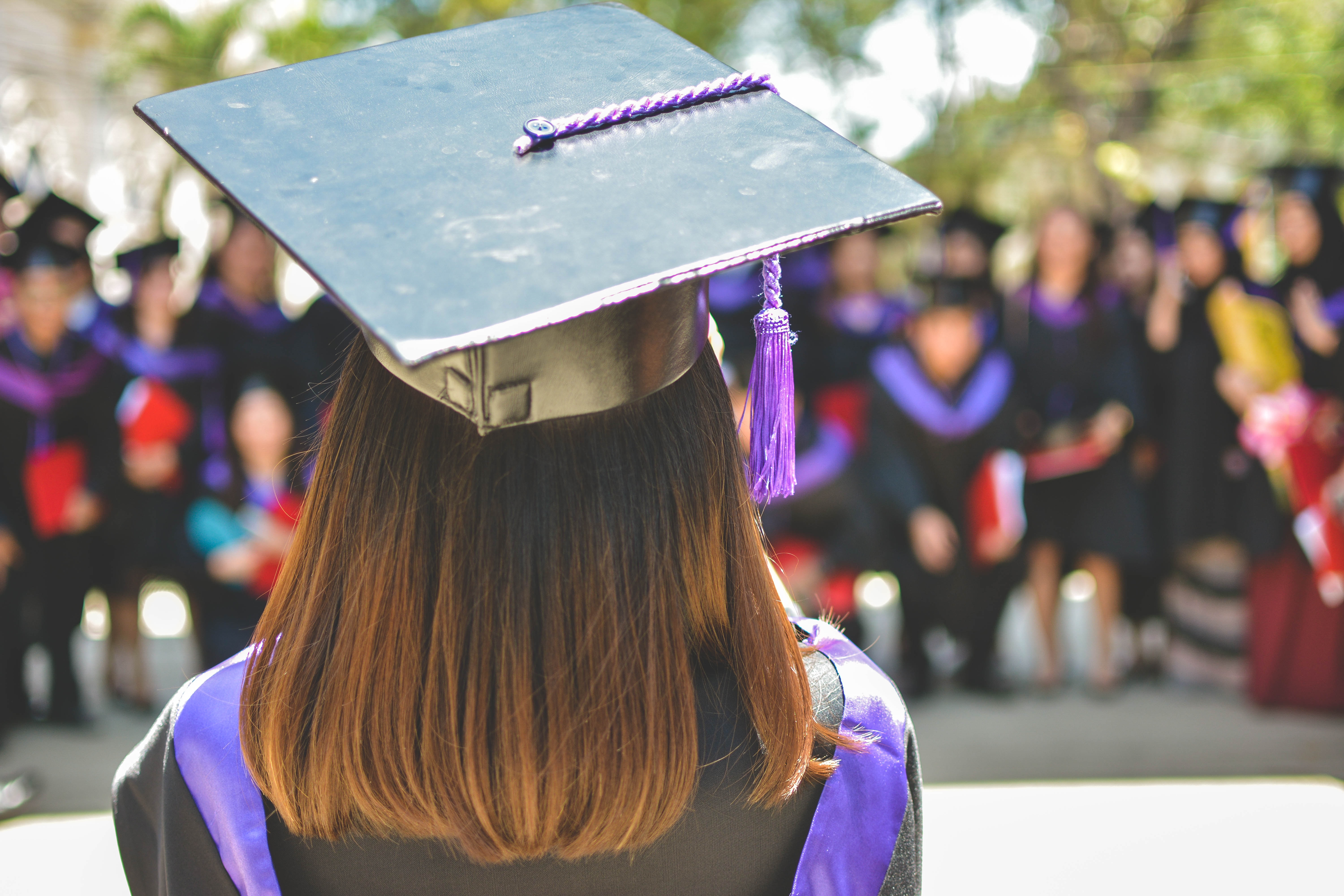 image of a person from behind wearing a graduation cam and gown