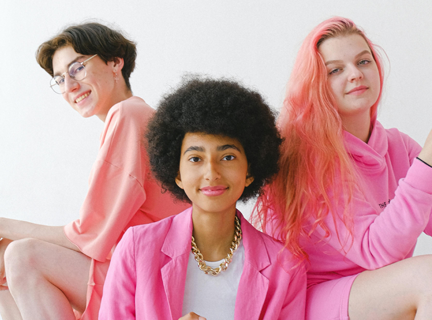 three people dressed in shades of pink