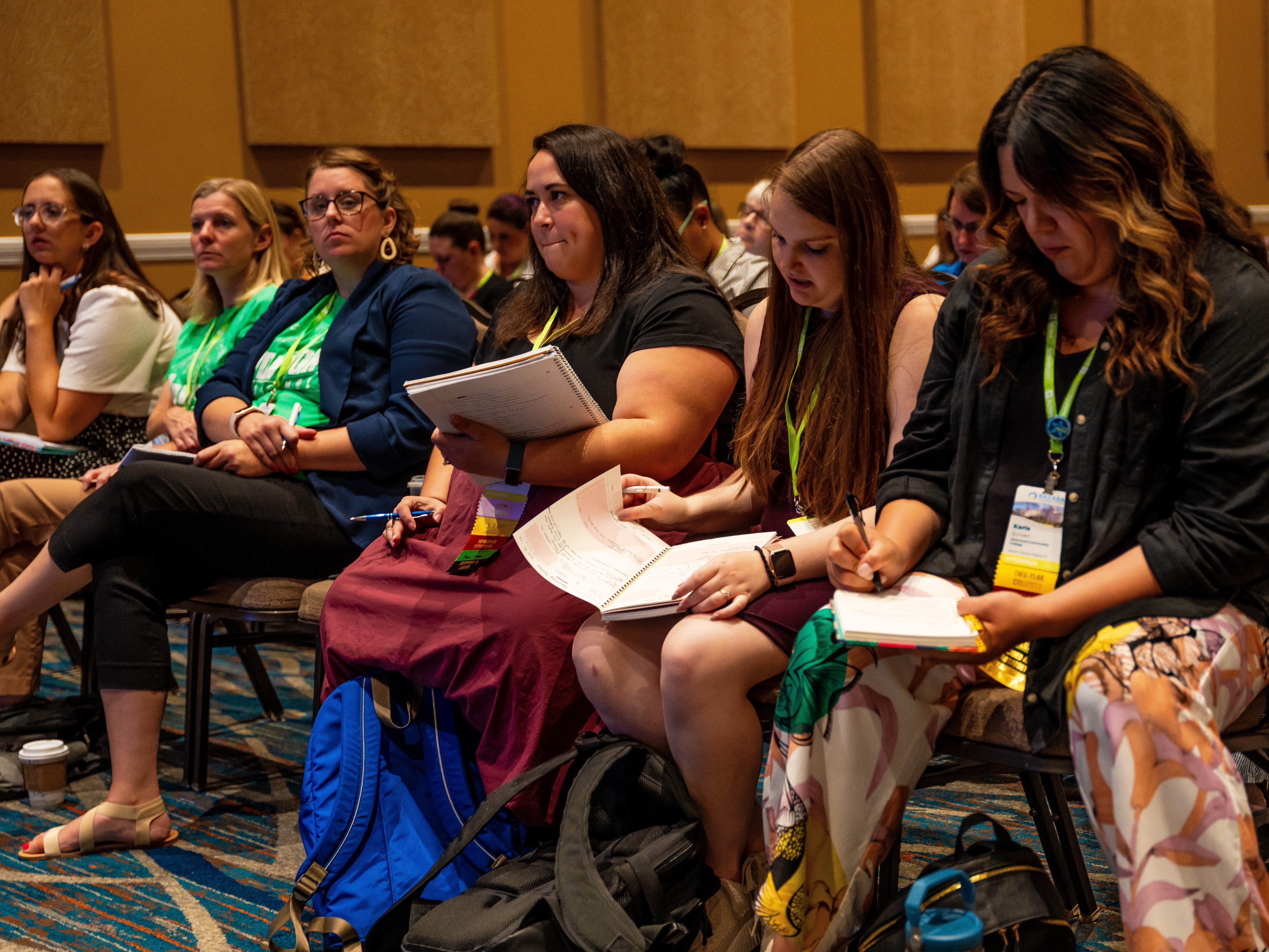 group of attendees at a conference taking notes