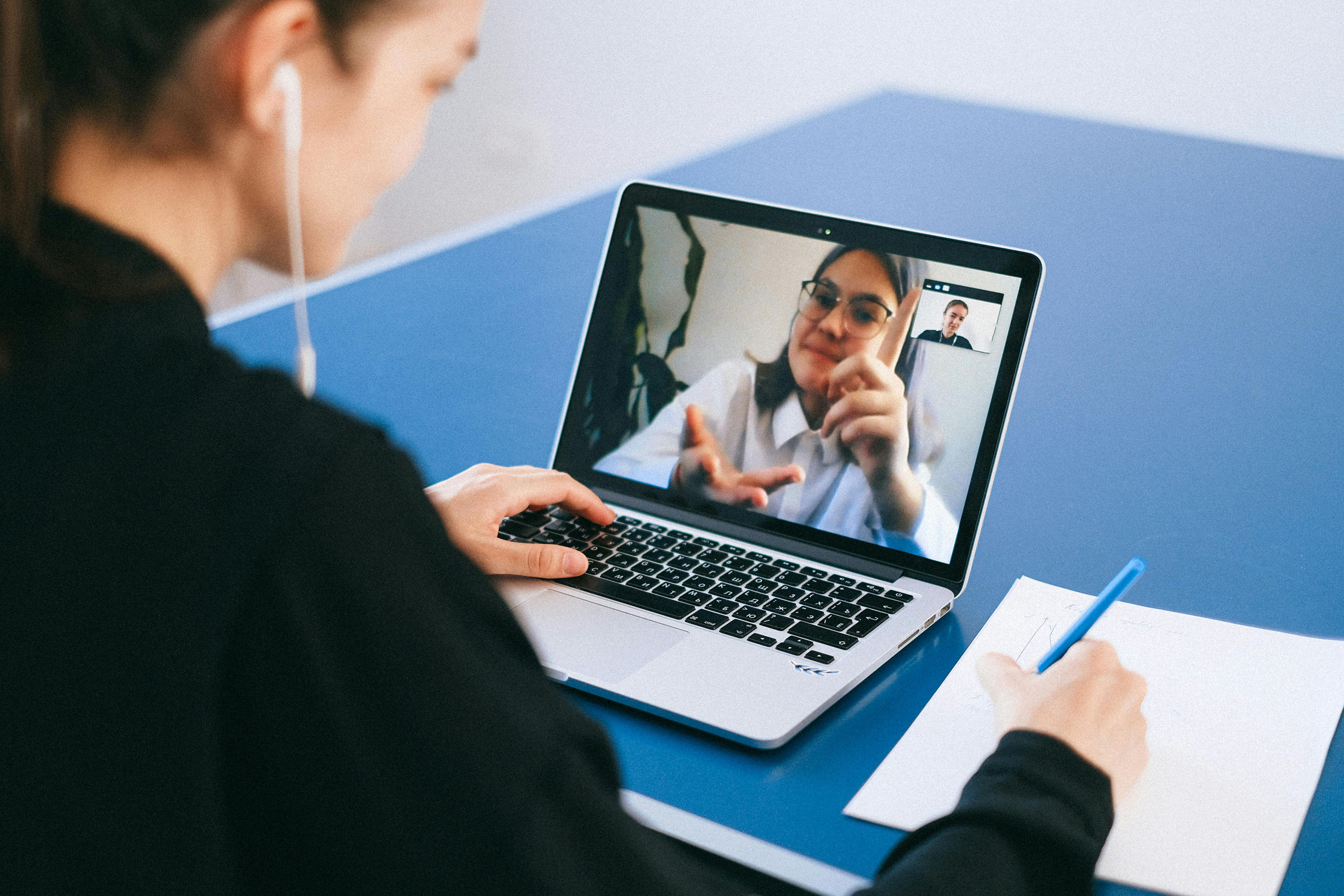 a person talking to another via online meeting softward